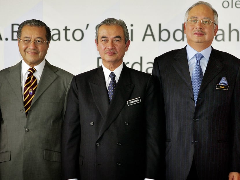 Former Malaysian Prime Minister Abdullah Ahmad Badawi (C) is flanked by his predecessor Mahathir Mohamad (L) and successor Najib Razak in this 2005 file photo. Photo: Reuters