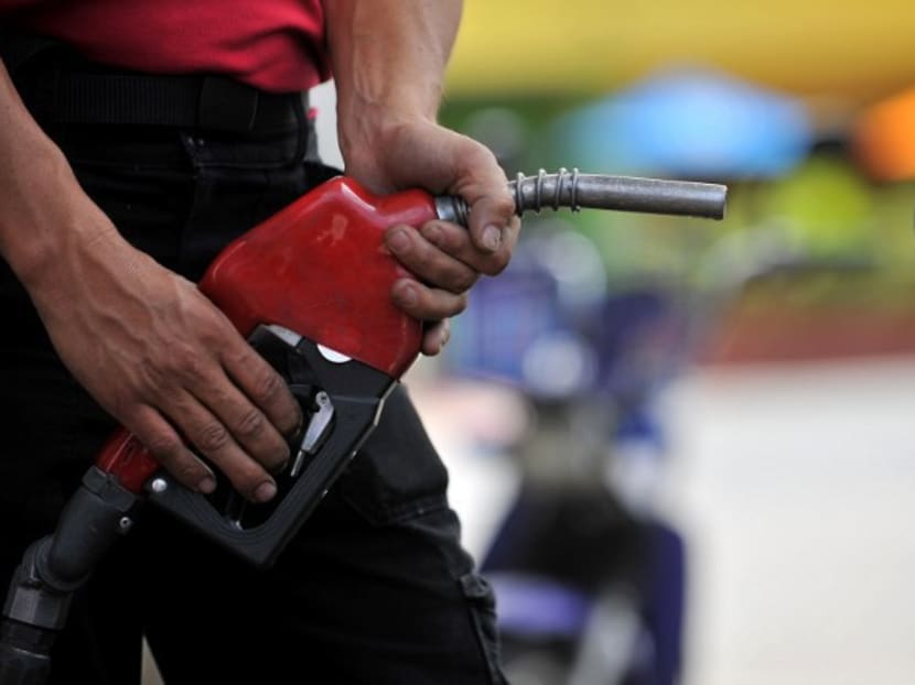 A worker refuels a car at a petrol station with biofuel in this 2009 file photo. Photo: AFP