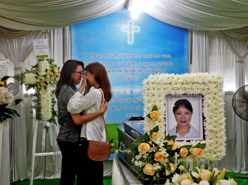 Former national gymnasts Megan Chong (left) and Ann Sim (right) react after paying their respects at the wake of gymnastics coach Zhu Xiaoping, on Jan 19, 2017. Ann was the captain of the 2015 SEA Games gymnastics team that took gold. Photo: Ooi Boon Keong/TODAY