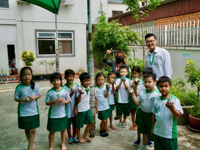 Mr Wang Junyong, 32, is a managing director of an international school in Cambodia. He is seen here with some K2 students and a teacher during an outdoor activity.  