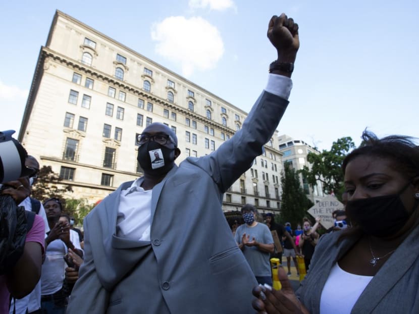 Mr Philonise Floyd, George Floyd's brother, holds up his fist as he marches with others on Black Lives Matter Plaza near the White House, to protest police brutality and racism, on June 10, 2020 in Washington, DC. Mr Philonise Floyd, George Floyd's brother, holds up his fist as he marches with others on Black Lives Matter Plaza near the White House, to protest police brutality and racism, on June 10, 2020 in Washington, DC.