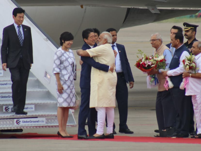Indian Prime Minister Narendra Modi (centre right), hugging Japanese Prime Minister Shinzo Abe as he met him at the airport in Ahmedabad, India, yesterday. Photo: AP