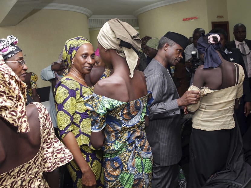 Nigerian Vice President Yemi Osinbajo, right, receives  some of the freed Chibok school girls at the state  House in Abuja, Nigeria, on Oct 13, 2016.  Photo via AP