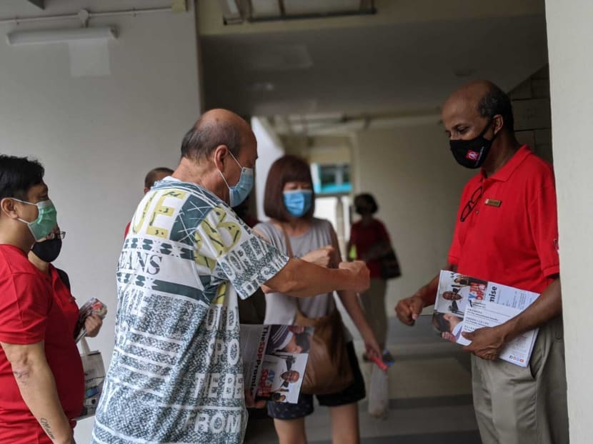 Singapore Democratic Party chairman Paul Tambyah (right) makes house visits in Pending Road, Bukit Panjang on July 3, 2020.