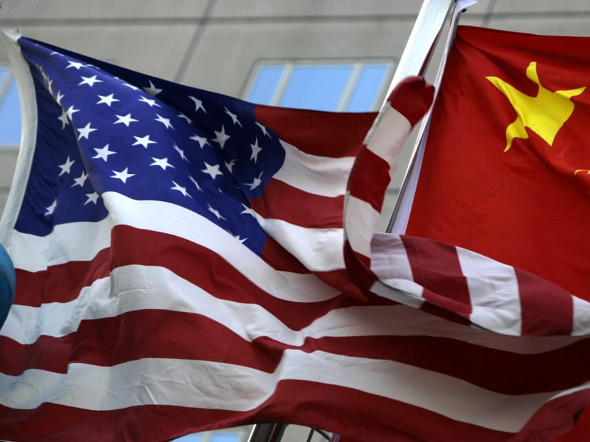 National flags of the United States and China wave in front of a hotel in Beijing. Washington and Beijing look to be preparing for a protracted confrontation over trade and investment as they each try to line up allies for their cause.