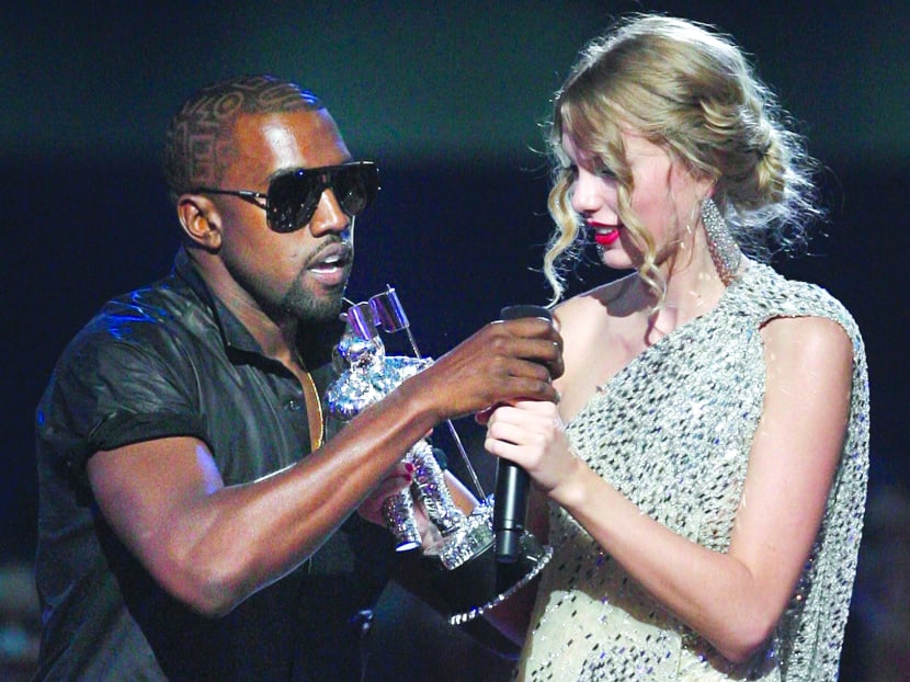In this Sept 13, 2009 file photo, singer Kanye West takes the microphone from singer Taylor Swift as she accepts the Best Female Video award during the MTV Video Music Awards in New York. AP file photo