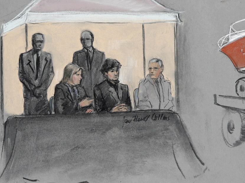 In this courtroom sketch, Dzhokhar Tsarnaev, centre-seated, is depicted between defense attorneys while the boat in which he was captured in sits on a trailer for observation during his federal death penalty trial. Photo: AP