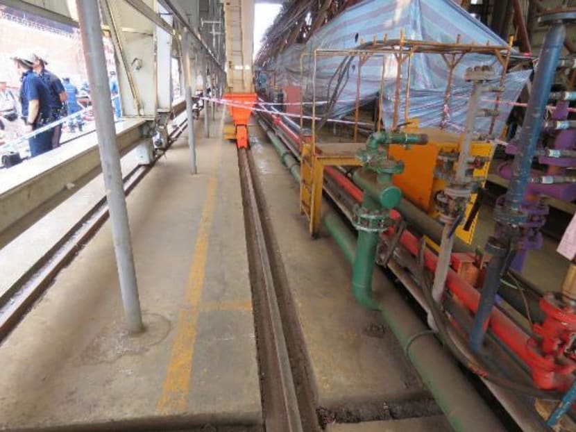 Photograph showing the measurement of the distance from the utility water supply manifold to the Gantry Crane Track.
