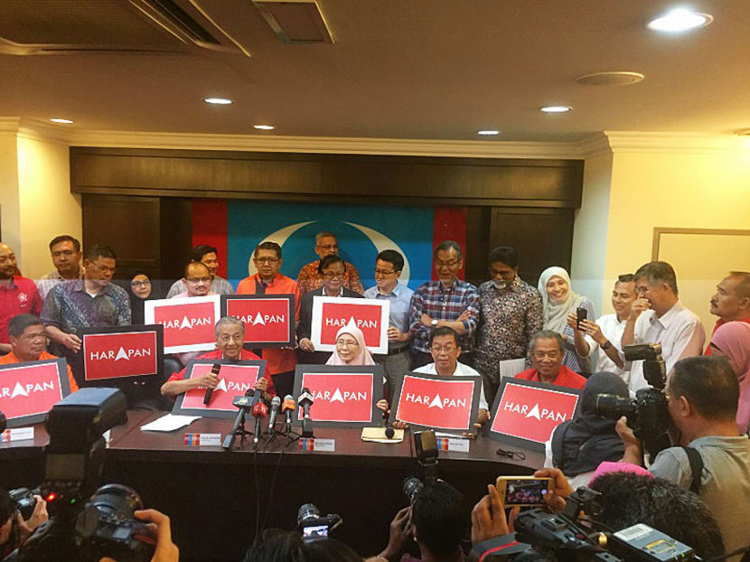 The leaders of Pakatan Harapan, including former prime minister Mahathir Mohamad (seated, second from left), showcase their new logo at a press conference in Kuala Lumpur last Thursday. Photo: Malay Mail Online