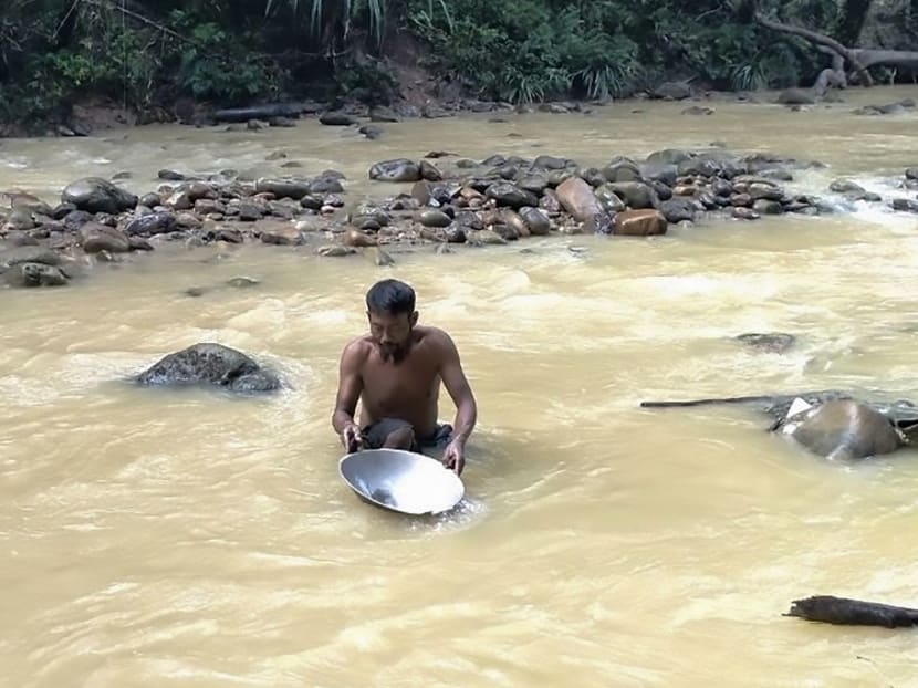 A miner pans for gold along a stream near Korowai, Papua province, July 7, 2020.