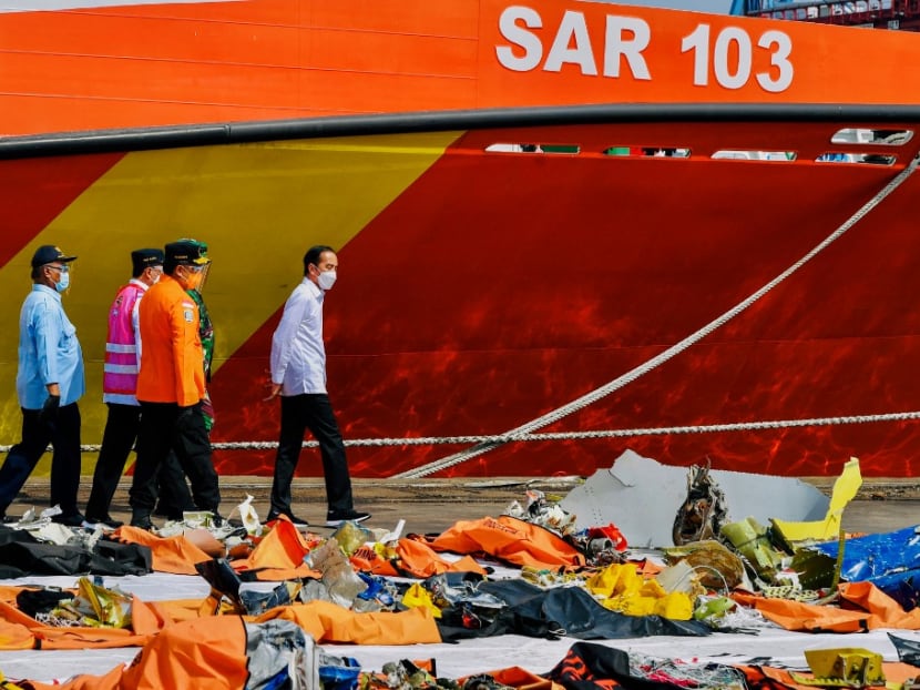 This handout picture taken and released on Jan 20, 2021 by Indonesia's Presidential Palace shows Indonesian President Joko Widodo visiting a port in Jakarta, where recovered wreckage and human remains from the ill-fated Sriwijaya Air flight SJ182 are being collected from the crash scene.
This handout picture taken and released on Jan 20, 2021 by Indonesia's Presidential Palace shows Indonesian President Joko Widodo visiting a port in Jakarta, where recovered wreckage and human remains from the ill-fated Sriwijaya Air flight SJ182 are being collected from the crash scene.