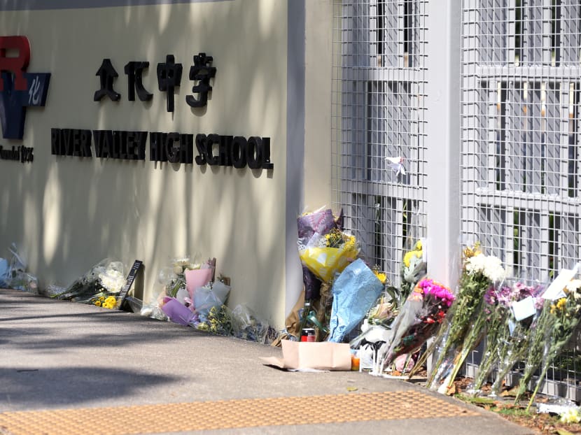 Bouquets of flowers seen left at the main gate of River Valley High School on July 25, 2021.