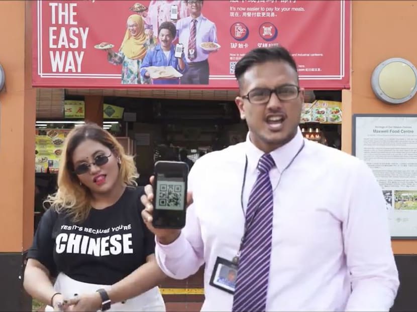A rap video posted on Facebook by Preeti Nair (left) featuring rapper Subhas Nair (right) was directed against an e-payment advertisement (in the background). A rap video posted on Facebook by Preeti Nair (left) featuring rapper Subhas Nair (right) was directed against an e-payment advertisement (in the background).