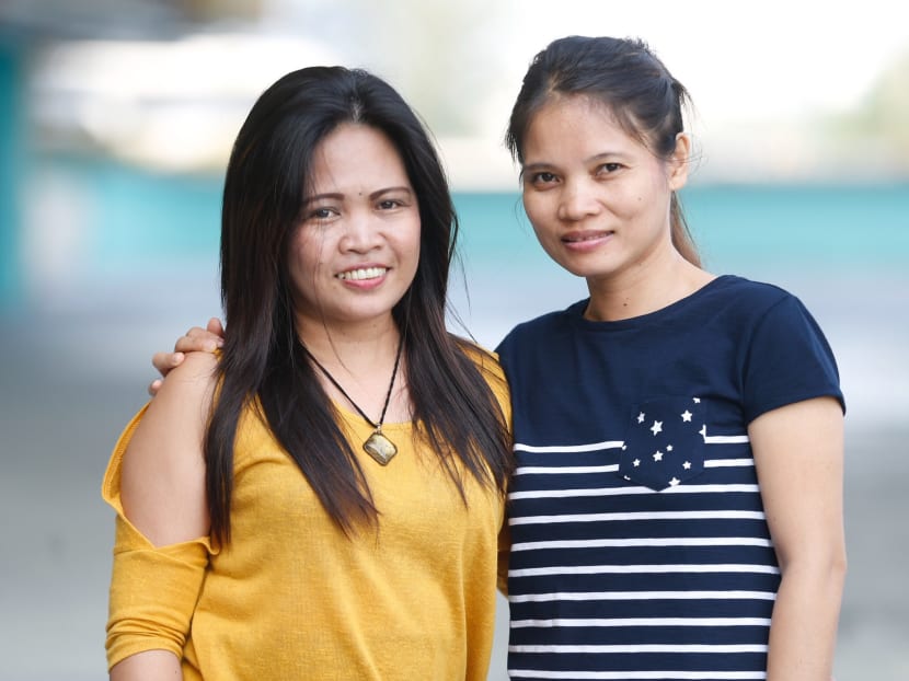While Filipina domestic helper Edna Degala (in yellow) worked in Singapore for the last 16 years looking after the children of her employers, her late parents and sister helped raise her daughter. She is seen here with her friend, Ms Vilma Laguinday, 43. Photo: Najeer Yusof/TODAY