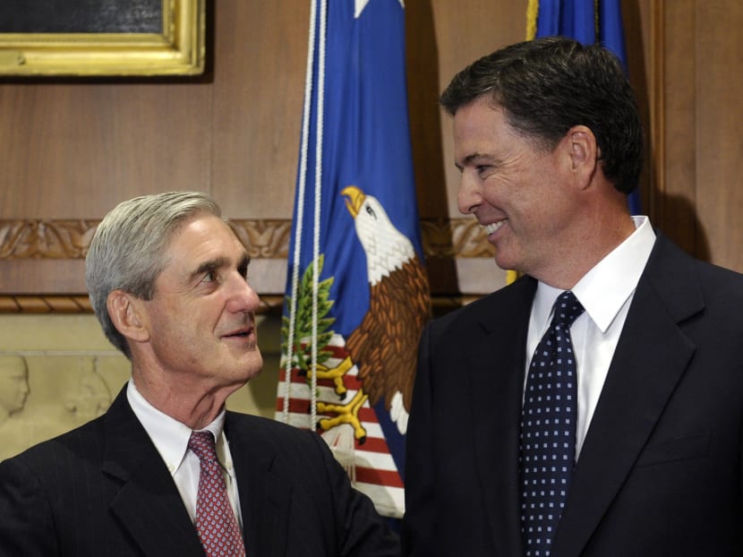 The former FBI Director James Comey talks with his predecessor Robert Mueller at the Justice Department in this file photo. AP file photo