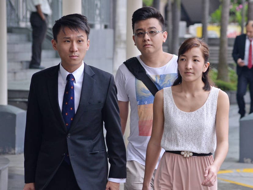 Mr Yang Kaiheng (centre), one of the former editors of The Real Singapore (TRS), and Ai Takagi (right), another fellow former editor, walking into the State Courts, with the lawyer on March 8, 2016. Photo: Robin Choo/TODAY
