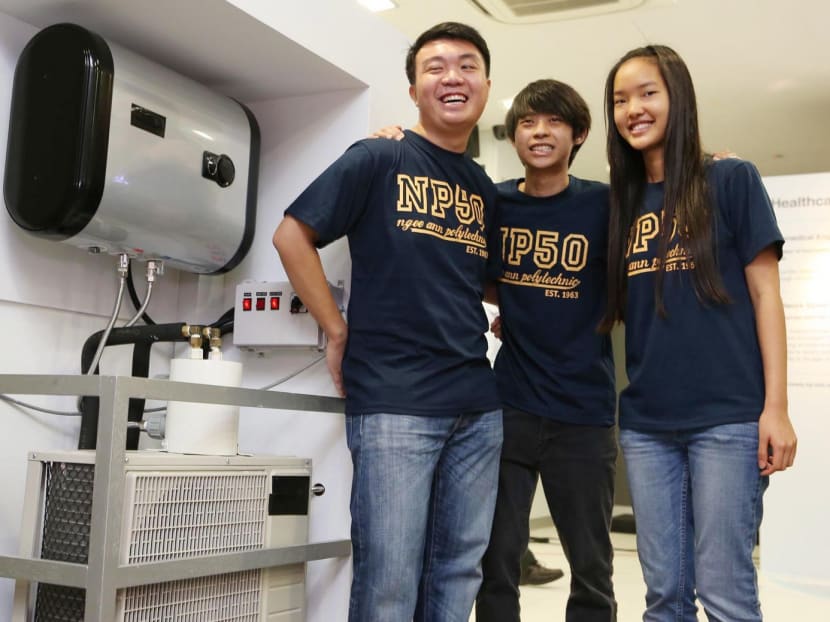 Ngee Ann Polytechnic mechanical engineering students (from left) Goh Ray Gin, Desmond Lou and Irene Carisa Lee’s Domestic Waste Heat Recovery System absorbs heat from air-con compressors. Photo: Wee Teck Hian