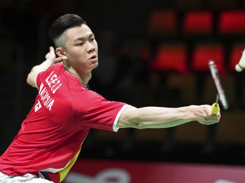 Malaysia's Lee Zii Jia competes with Japan's Kento Momota during a men's single match in the Thomas Cup men's team Badminton match between Japan and Malaysia in in Aarhus, Denmark, on Oct 14, 2021.
