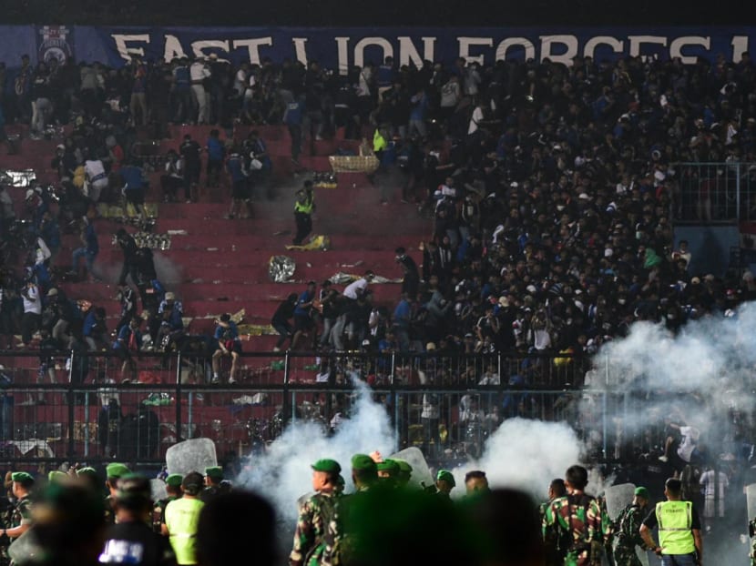 This picture taken on Oct 1, 2022 shows security personnel on the pitch at Kanjuruhan Stadium in Malang, East Java.