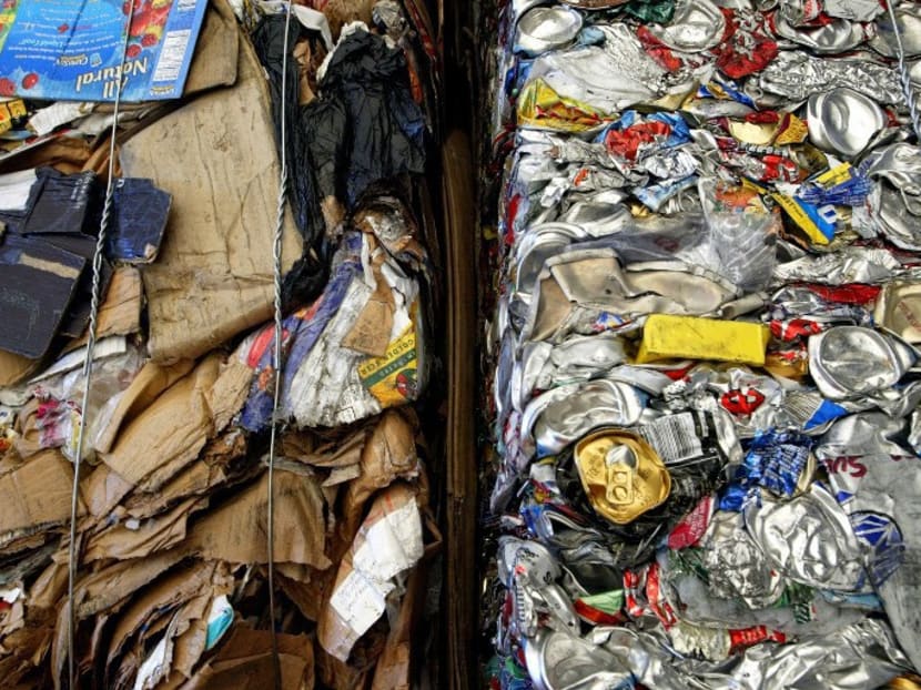File photo of cardboard and aluminium cans seen side by side. Photo: AFP