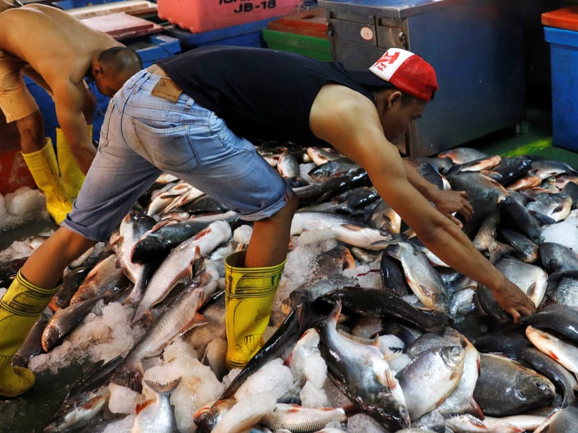 Fishermen sort out their catch at a wet market in Malaysia's southern city of Johor Baru. 