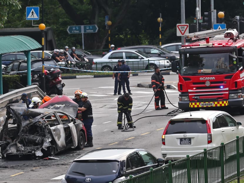 The charred taxi along Commonwealth Avenue on Sunday afternoon (April 30). Photo: Wee Teck Hian/TODAY