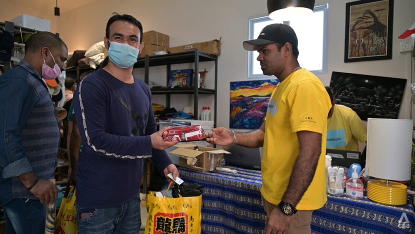 itsrainingraincoats migrant worker receiving present smiling