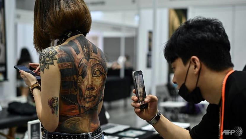 Malaysia slams tattoo expo as 'porn' over half-naked pics
