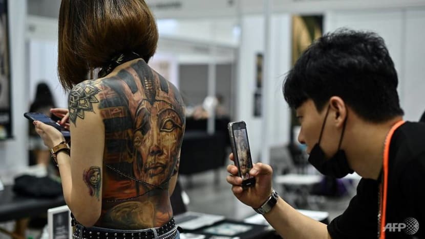 Malaysia slams tattoo expo as 'porn' over half-naked pics Malaysia slams tattoo expo as 'porn' over half-naked pics