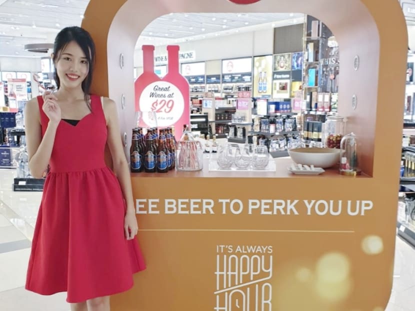 The author working at Changi Airport during a school vacation job in 2015 where she handed out beer samples.