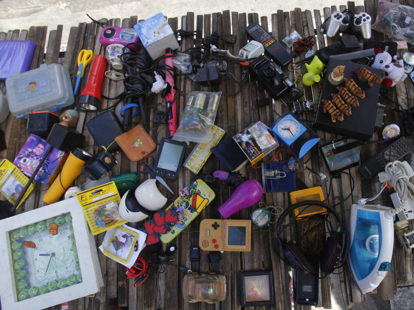 Unwanted electronic and electrical goods sell on a sidewalk in Bangkok. Photo: AP