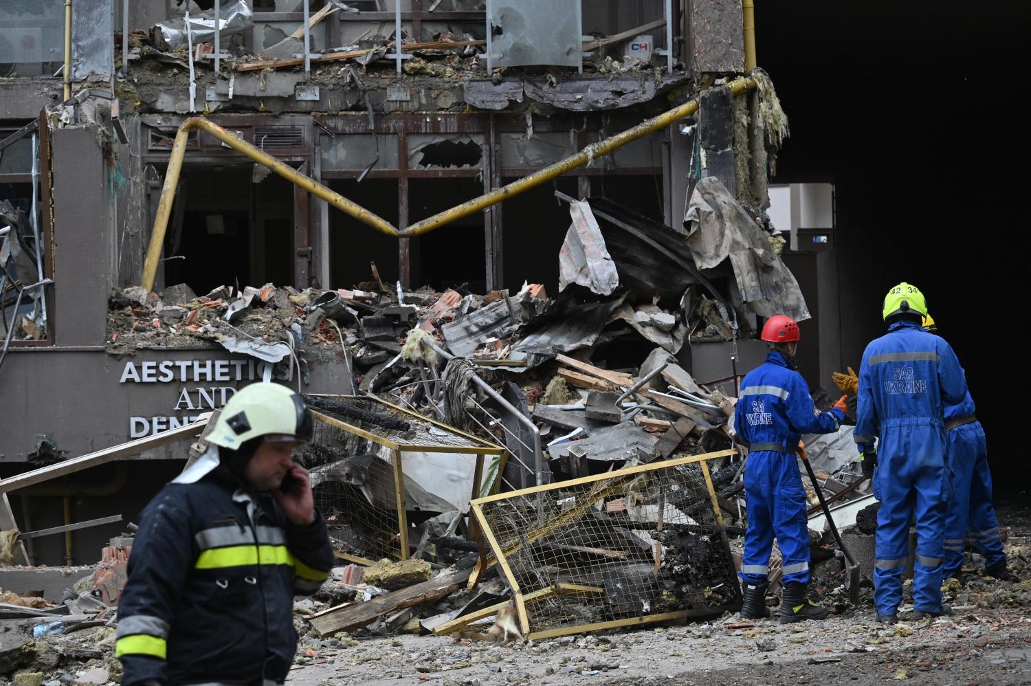 Ukrainian rescuers work outside a damaged residential building hit by Russian missiles in Kyiv on June 26, 2022, amid Russian invasion of Ukraine. Ukrainian rescuers work outside a damaged residential building hit by Russian missiles in Kyiv on June 26, 2022, amid Russian invasion of Ukraine.