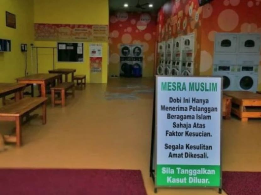 A sign at a self-service laundromat in Muar barring non-Muslim users. The owner said he was doing his duty as a Muslim and that the policy was in place for reasons of ‘kesucian’, or ‘purity’. Photo: Malay Mail Online