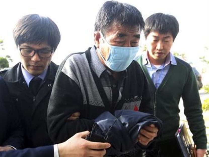 File photo of Lee Joon-seok (center), the captain of the sunken ferry boat Sewol, arriving at the headquarters of a joint investigation team of prosecutors and police in Mokpo, south of Seoul, South Korea.  Photo: AP