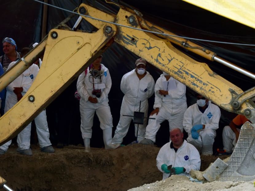 Forensic medical personnel work in the exhumation of 116 bodies found in a mass grave at Tetelcingo community in Morelos State, Mexico, in this file photo. Photo: AFP