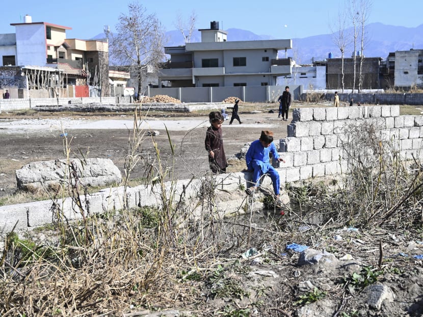 Boys play at the site of the demolished compound of slain former Al-Qaeda leader Osama bin Laden in northern Abbottabad, Pakistan on Feb 11, 2021.