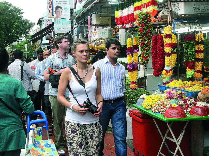 Tourists seen around Little India on 19 Dec 2013. Of the five travel agencies contacted by TODAY, only one cancelled tours after the riot. Photo: Ooi Boon Keong