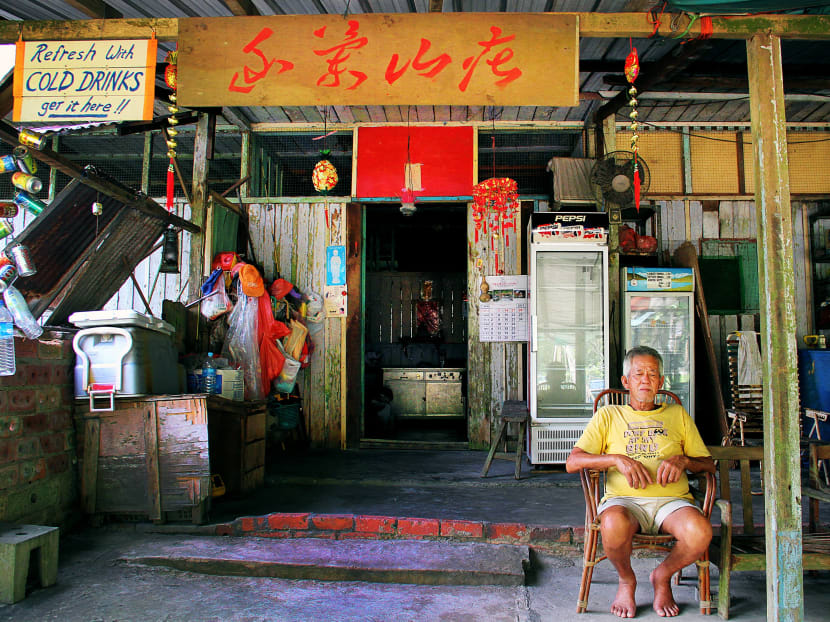 Mr Lim Chong Gan, 71, was born on Pulau Ubin. He sits outside his home which doubles up as a refreshments stall for cyclists on the island. He has two children, both of whom live on mainland Singapore. Photo: Alex Westcott/TODAY