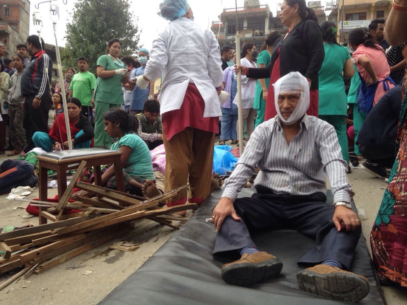 Injured people receive treatment outside the Medicare Hospital in Kathmandu, Nepal, Saturday, April 25, 2015. A strong magnitude-7.9 earthquake shook Nepal's capital and the densely populated Kathmandu Valley before noon Saturday, causing extensive damage with toppled walls and collapsed buildings, officials said. Photo: AP