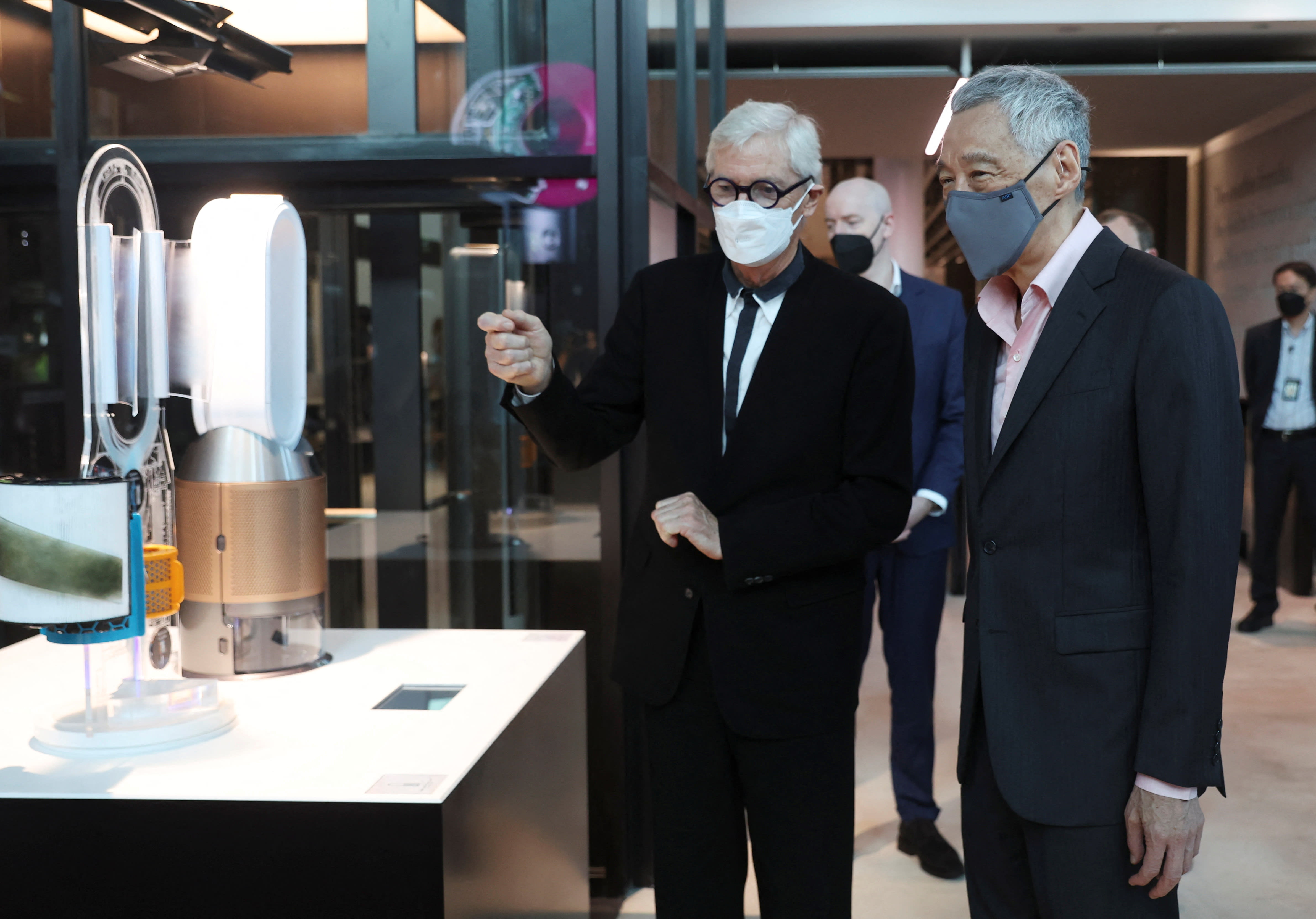 (Left) James Dyson and Singapore's Prime Minister Lee Hsien Loong tour Dyson's new global headquarters at St James Power Station in Singapore on March 25, 2022. 
