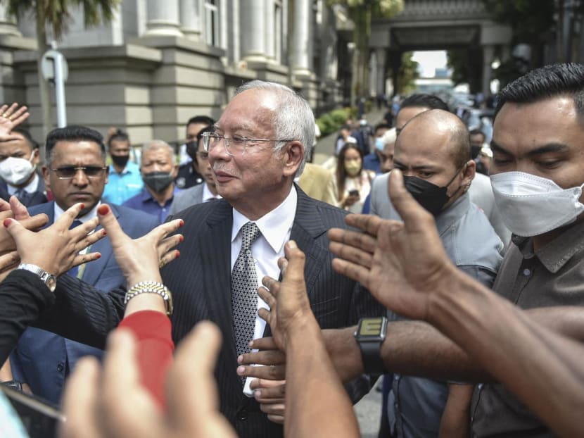 Malaysia's former prime minister Najib Razak (centre) greets supporters during a break in his appeal trial at the federal court in Putrajaya, on Aug 23, 2022.
