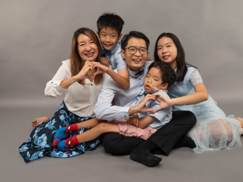 Phua Wenjie, 14, in the arms of his father Phua Wee Seng, surrounded by his mother Yeo Kheng Hui (far left) and his siblings Phua Wenxin (far right), 16, and Phua Wenze (second from left), 10.

