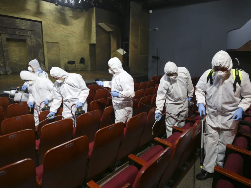 Workers wearing protective gears, spray disinfectant as a precaution against the Middle East Respiratory Syndrome virus at an art hall in Seoul, South Korea, June 18, 2015. Photo: AP