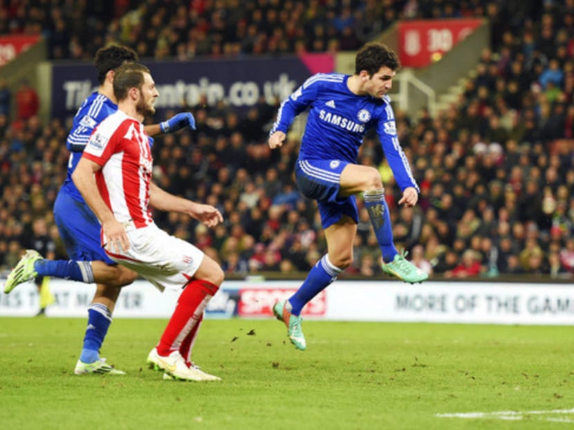 Fabregas (right) scoring Chelsea’s second goal during the match with Stoke City. Photo: Getty Images