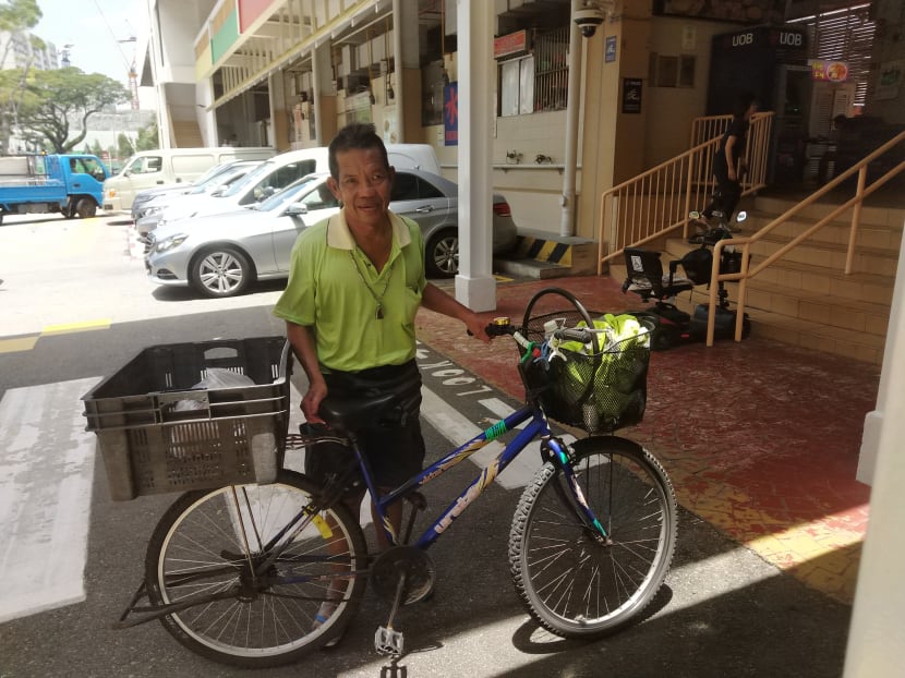 Mr Chia Meng Guai with his bicycle at Old Airport Road Food Centre, where he picks up food items from Jun Yuan House of Fish stall for delivery.