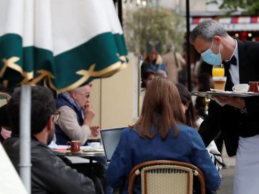 Parisians tuck into coffee and croissants again as cafes re-open Parisians tuck into coffee and croissants again as cafes re-open