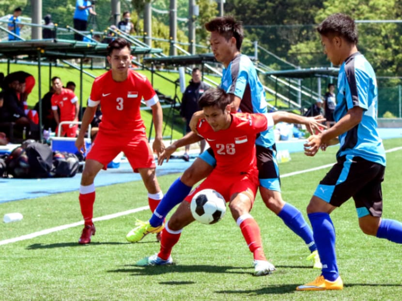 Singapore Under-23’s  Christopher van Huizen (centre) fends off an Azul Claro Numazu player. The team’s recent loss raises more questions about their ability to compete with regional rivals.  Photo: Football Association of Singapore