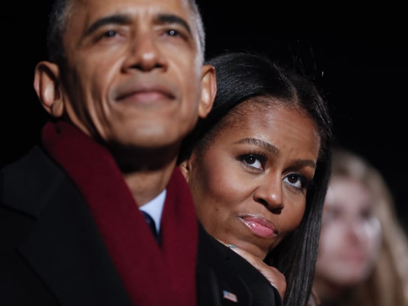 Mrs Michelle Obama and Mr Barack Obama watching the musical performances at the 2016 National Christmas Tree lighting ceremony at the Ellipse near the White House in Washington on Dec 1, 2016. Photo: AP
