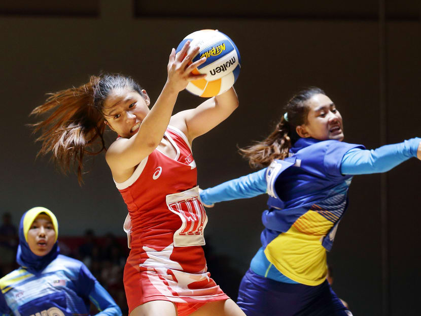 Netballer Kimberly Lim (with ball) said her sole source of financial help came from the Peter Lim Scholarship and the money helped her hone her focus on matters on the court. Photo: Getty Images