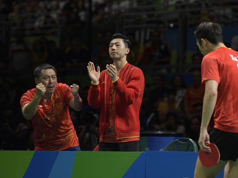 Then China head coach Liu Guoliang (left) cheering his player Xu Xin (right) on during the men's team gold medal table tennis match against Japan's Jun Mizutani at the Rio 2016 Olympic Games. Photo: AFP